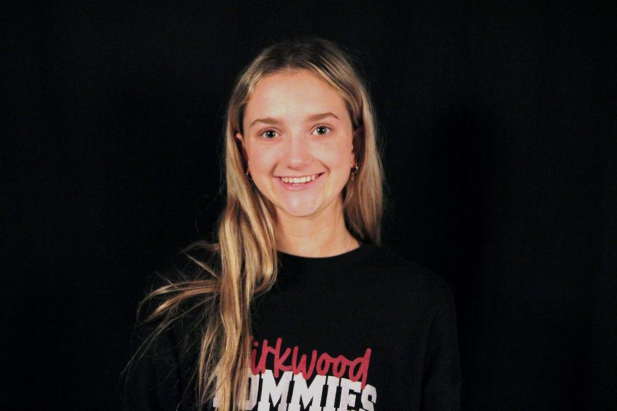 Avery Campbell, freshman, poses for a photo in her varsity pommie merch.