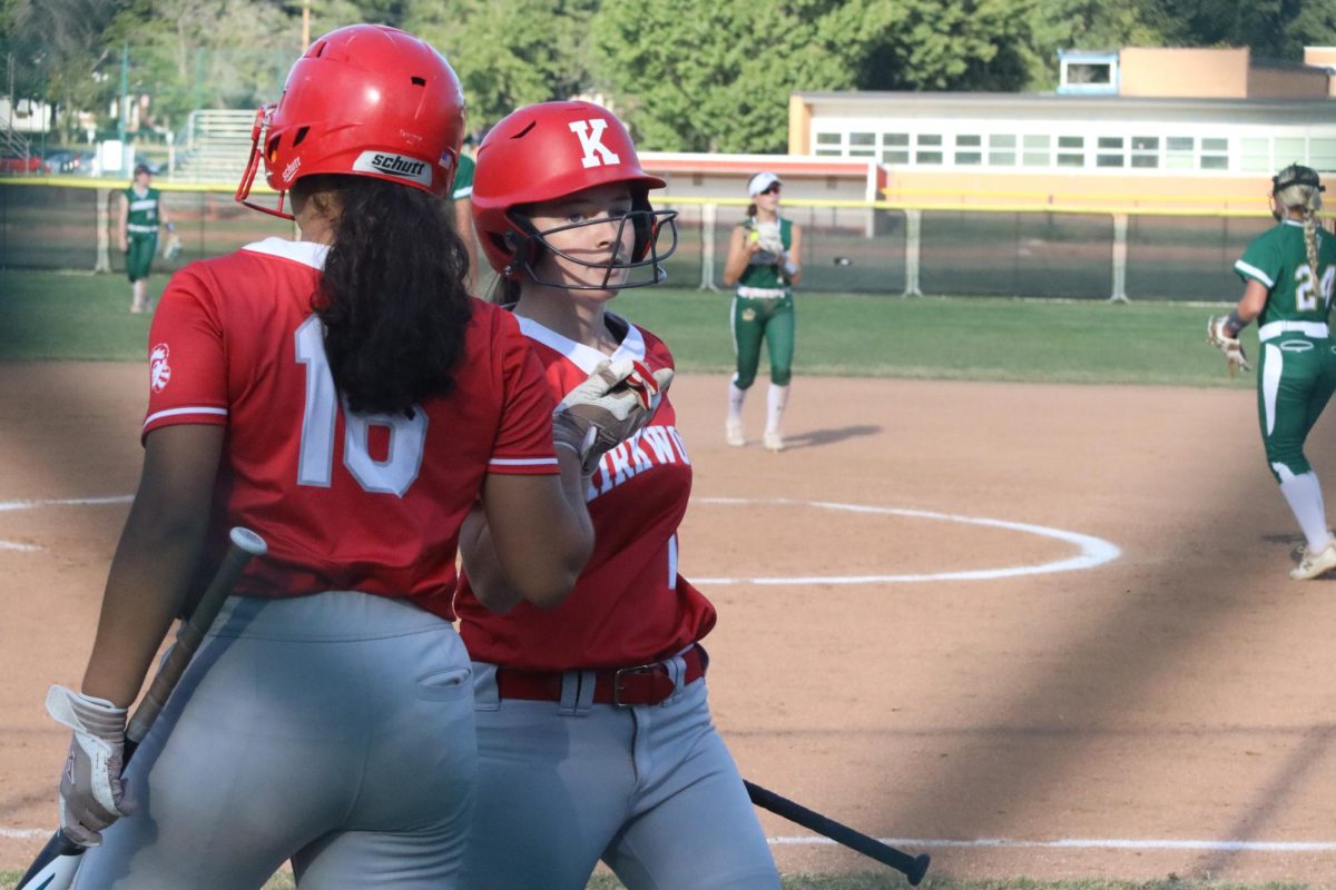 Solis Maldonado, sophomore, and Carmen Fort, junior, high five as Solis comes up to bat.