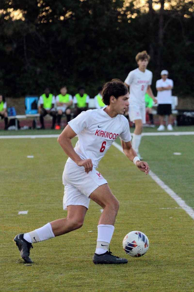 Luke Butler, junior, dribbles the ball up the field as Kirkwood prepares to go on the attack.