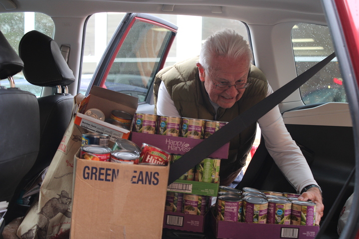 Volunteers at KirkCare picks up food drive items from KHS.