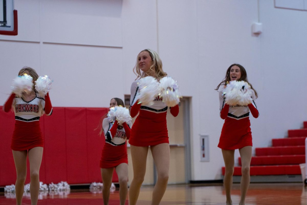 Carly Smith holds her white poms, dancing her competition dance.