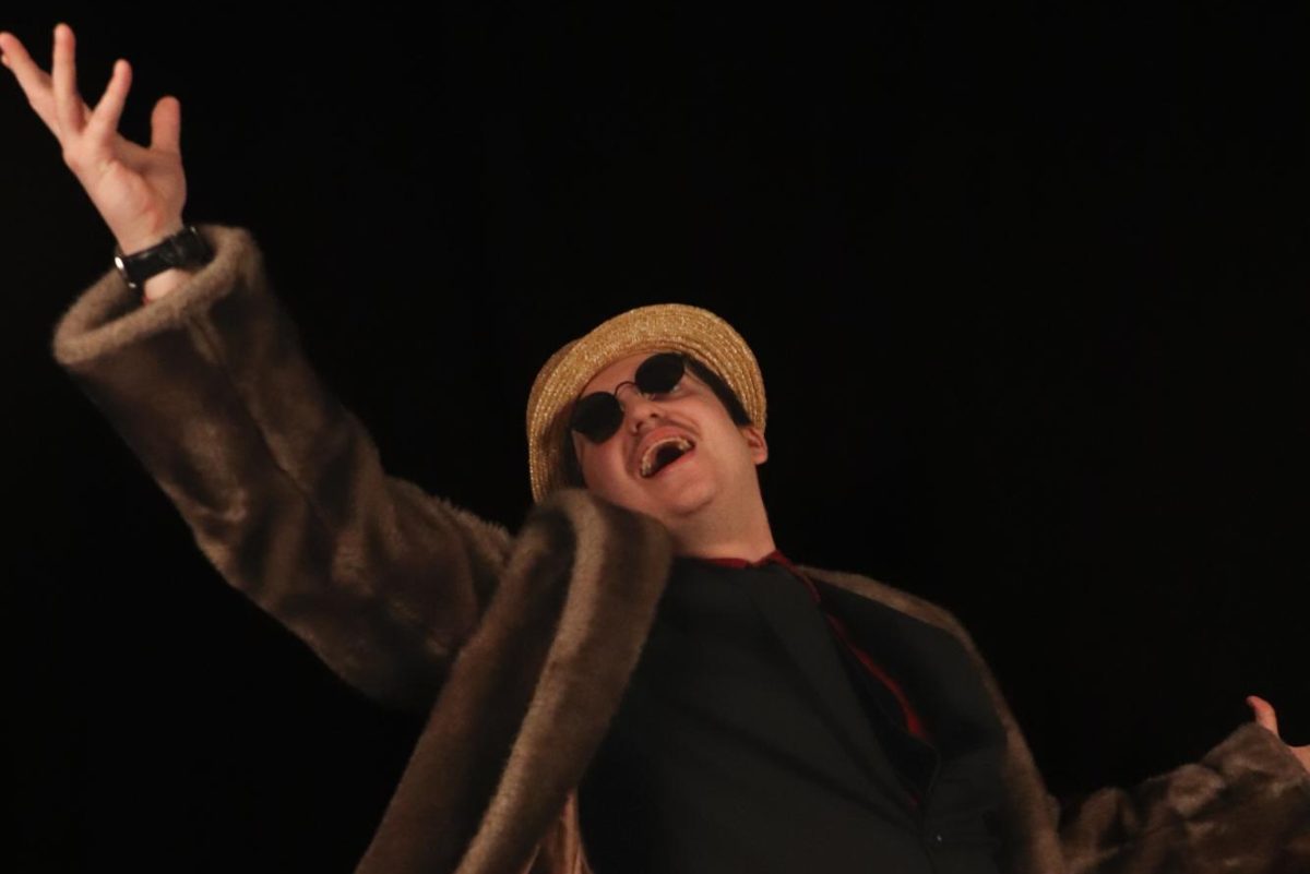 David Gaither poses in his fur coat and boater hat.